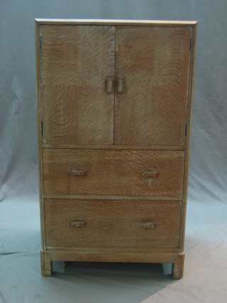 A 1950's Heales limed oak tall boy enclosed by a panelled door, the base fitted 2 drawers 24" (no label)