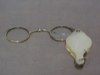 A pair of mother of pearl and white metal lorgnettes (some damage to case)