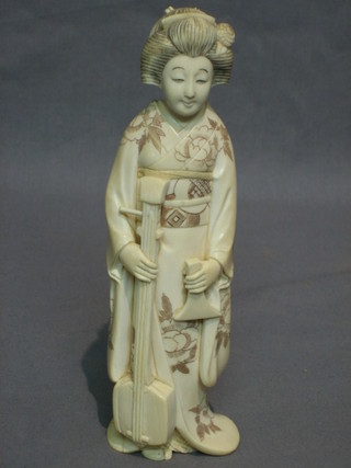 A 19th Century Japanese carved ivory figure of a standing musician 7"