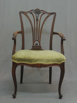 An Edwardian mahogany open arm carver chair with vase shaped splat back, having an upholstered seat and raised on French cabriole supports