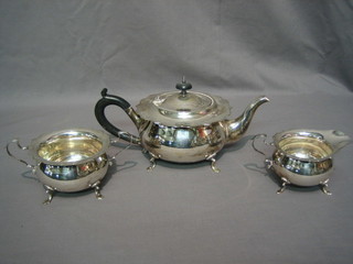 A circular 3 piece silver plated tea service with teapot, twin handled sugar bowl and cream jug