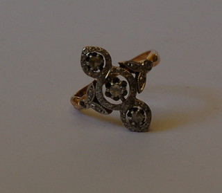 A Continental gold dress ring set 3 diamonds set further smaller diamonds