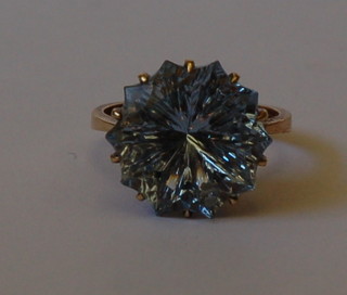 A lady's 9ct gold dress ring set a blue circular cut stone