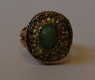 A lady's gold dress ring set a cabouchon cut turquoise surrounded by brilliants