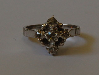 A white gold cross-over dress ring set 5 diamonds