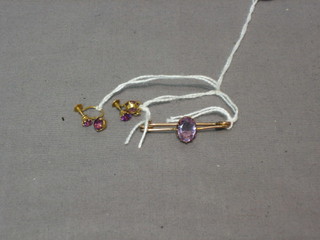 A gold bar brooch set an oval amethyst and 2 matching earrings