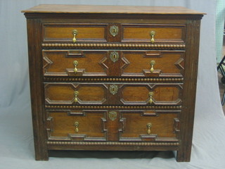 A 17th Century Continental oak chest of 4 long drawers, with geometric moulding to the front 37"