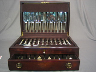 A 113 piece canteen of Old English and rat tail patterned flatware by Harrods comprising 12 table knives, 12 tea knives, 12 fish knives and forks, a carving knife fork and steel, 11 teaspoons, 11 pudding forks, 12 soup spoons, 11 table spoons, 12 table forks and 4 table spoons, all contained in a mahogany canteen box