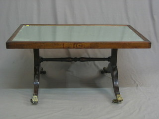 A 19th Century rectangular plate cheval mirror converted for use as a coffee table, raised on scroll supports 42"