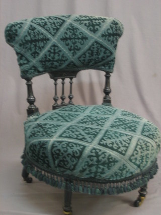A Victorian ebonised chair with bobbin turned decoration, upholstered in blue material and raised on turned and fluted supports 