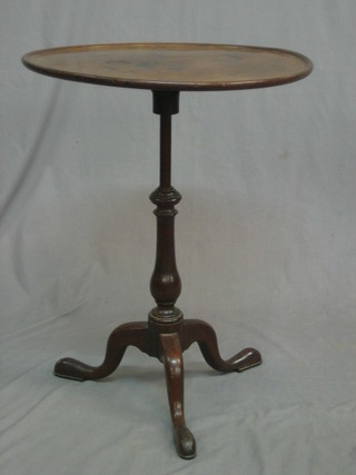 A 19th Century circular mahogany tray top wine table, raised on a pillar and tripod base 23"