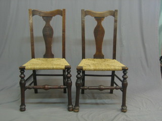 A set of 5 18th Century style oak slat back dining chairs with woven cane seats, raised on club supports united by stretchers