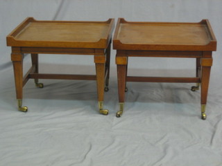 A pair of rectangular Georgian style mahogany tray top coffee tables, raised on square tapering supports ending in brass caps and castors 18"