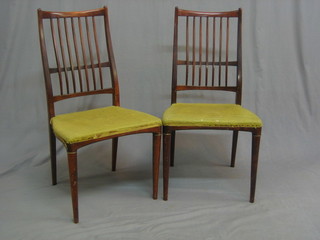 A set of 4 1960's rosewood stick and rail back dining chairs