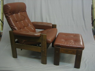 A 1960's oak framed reclining armchair upholstered in brown hide together with a matching foot stool