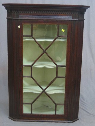 A Georgian mahogany corner cabinet with moulded and dentil cornice, the interior fitted shelves enclosed by astragal glazed panelled doors 29"
