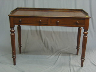 A Victorian mahogany side table with three-quarter gallery fitted 2 drawers, raised on turned supports 41"