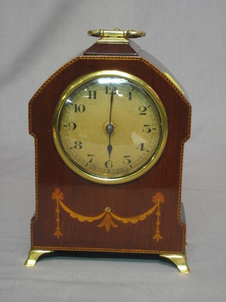 A bedroom timepiece with Roman numerals, contained in a mahogany case
