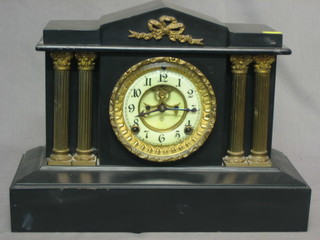 A Victorian American 8 day striking mantel clock with visible escapement and enamelled dial contained in an iron case