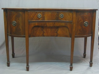 An Edwardian Georgian style shaped mahogany sideboard, fitted 2 drawers flanked by bow front cupboards, raised on square tapering supports ending in spade feet 54"