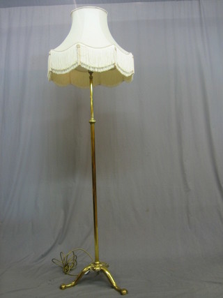 An Art Nouveau brass adjustable standard lamp