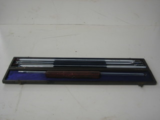 5 13" glass thermometers and a 5" glass thermometer contained in a leather case