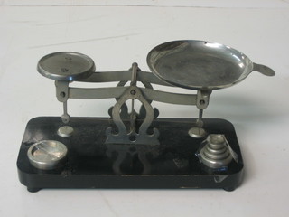 A pair of chromium plated scales, raised on an ebonised base 5"