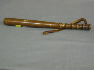 A turned wooden truncheon