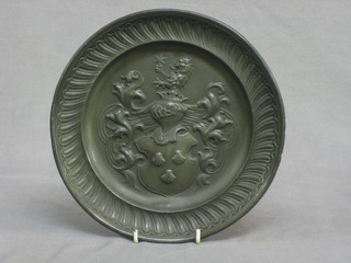 A Continental embossed pewter plate with armorial decoration the reverse with 3 touch marks 9"