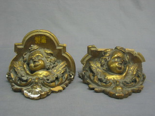 A pair of 19th Century carved wood and plaster wall brackets in the form of cherubs 8"