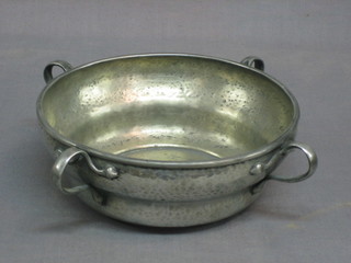 An Art Nouveau circular planished pewter dish with 4 handles, the base marked English pewter 1175 8"