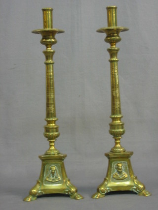 A pair of 19th/20th Century brass Rococo candlesticks raised on shaped bases 18"