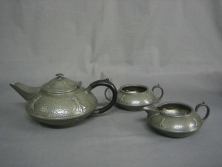 A 3 piece Art Nouveau embossed and planished pewter coffee service by Civic with teapot, twin handled bowl and cream jug, base marked 3476