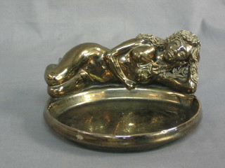 A gilt pottery ashtray decorated a reclining naked lady 7"