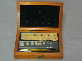 A set of gold scales contained in a mahogany case