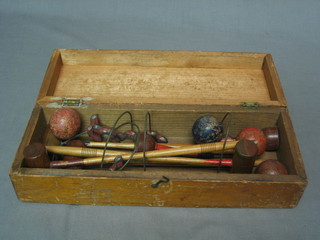 A table croquet game with 5 hoops, 3 balls and 4 mallets, boxed