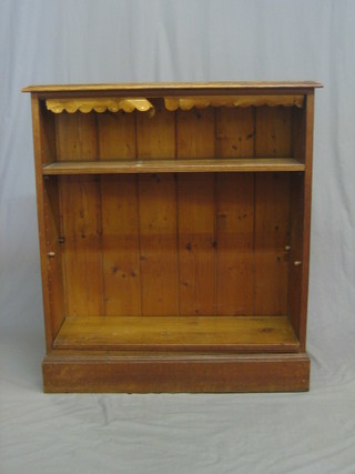 A Victorian honey oak bookcase, fitted adjustables shelves and raised on a a platform base 36"