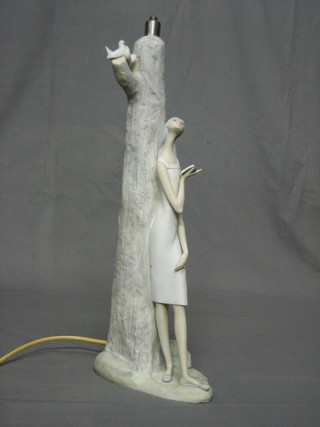 A Lladro biscuit porcelain table lamp base in the form of a standing lady reading a book by a tree (f), base impressed Lladro Espania 16"