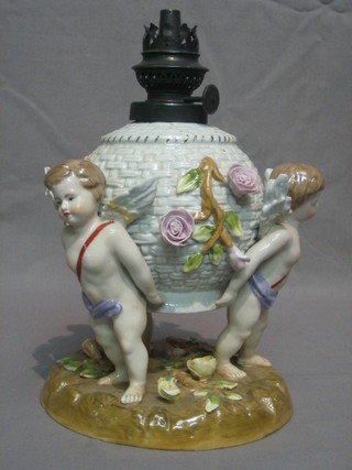A Meissen style porcelain oil lamp base in the form of cherubs 7"