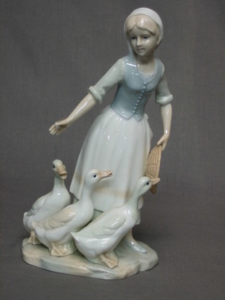 A Lladro style figure of a standing girl with geese 9" and a Continental Ragamuffin figure