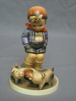 A Goebel figure of a boy with 2 pigs 5"
