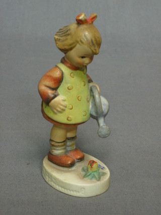 A Hummel figure of a standing girl with watering can, the base marked 74,  4 1/2"