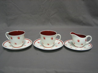 A Susie Cooper  red and white pottery "Early Morning Tea Set" comprising 2 tea cups and 2 saucers, cream jug and sugar bowl