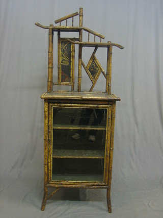 A 1930's bamboo cabinet with raised back, the base fitted a cupboard enclosed by a glazed panelled door 22"