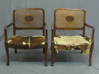 A pair of Art Deco walnut open armchairs, the seats upholstered in hide