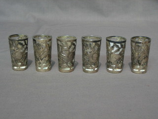 A set of 6 foreign glass shot glasses contained in pierced frames 2" (1f)