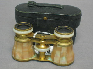 A pair of gilt metal and mother of pearl opera glasses complete with leather carrying case
