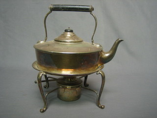 A circular silver plated tea kettle and stand