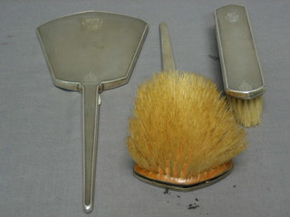 An Art Deco 3 piece silver backed dressing table set with hand mirror, hair brush and clothes brush, Birmingham 1936
