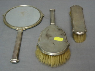 An Art Deco 3 piece silver backed dressing table set comprising hand mirror, hair brush and clothes brush, Birmingham 1933